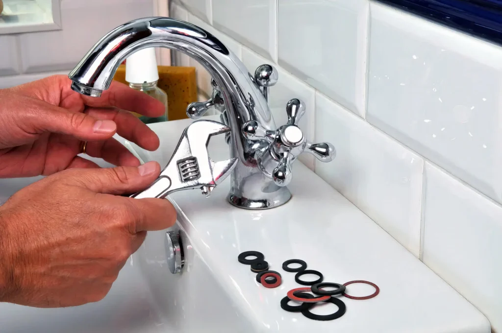 Plumber performing maintenance on a bathroom faucet in Winter Haven