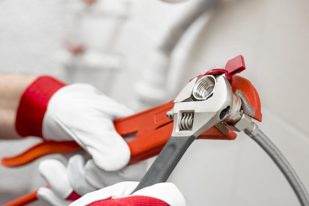Plumber holding pipe wrenches for an emergency repair in Winter Haven