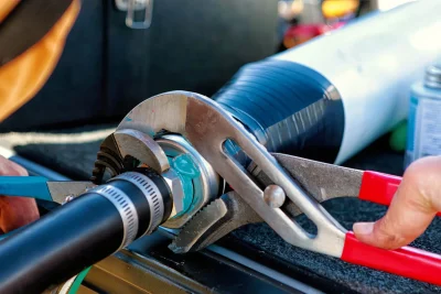 Technician tightening an industrial pipe connection in Winter Haven