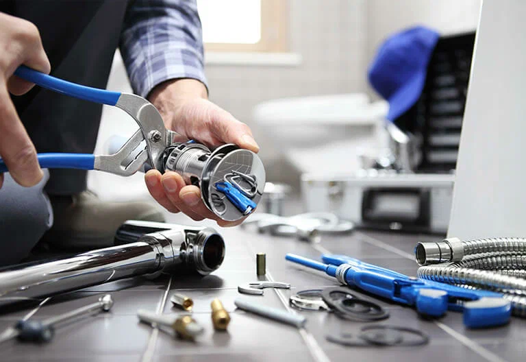 Technician repairing a plumbing fixture with professional tools in Winter Haven