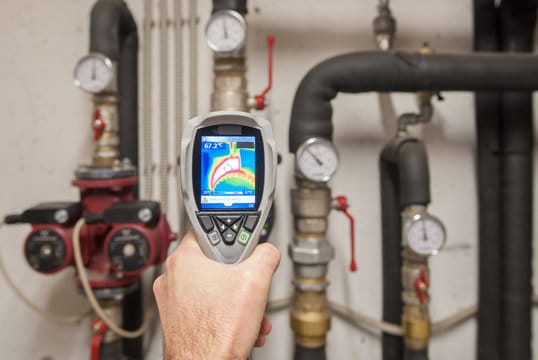 Plumber using a thermal imaging camera to inspect pipes in Winter Haven