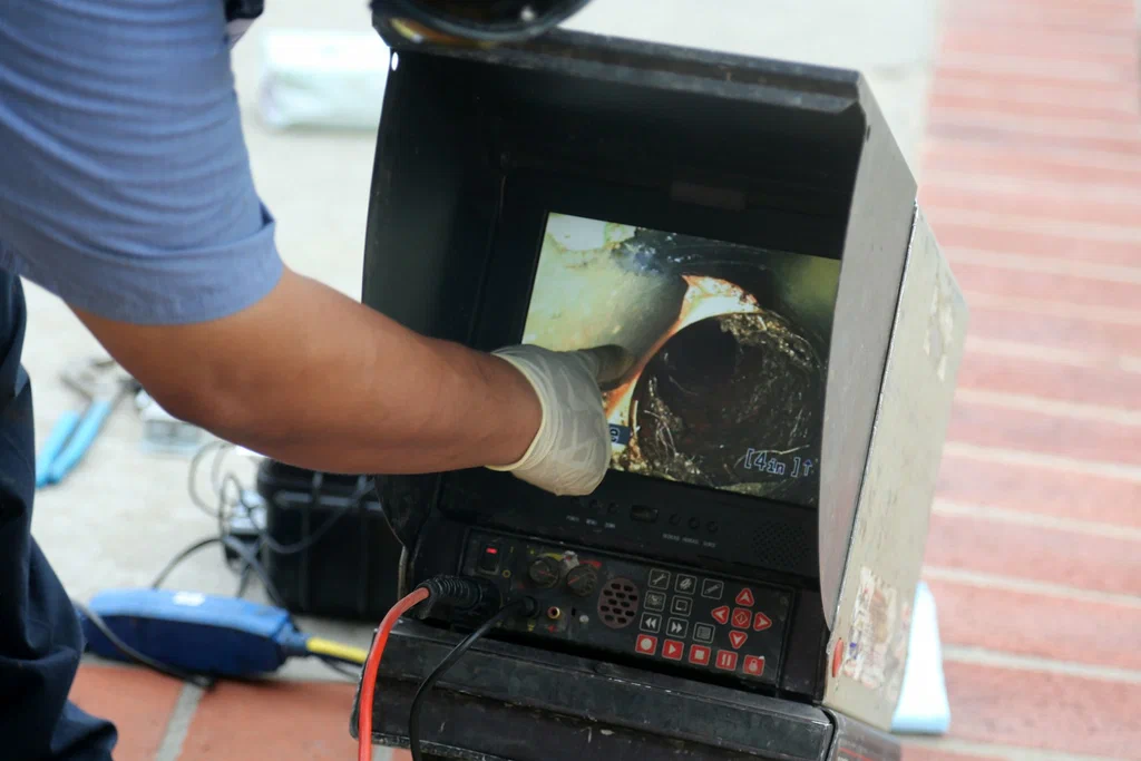 Technician viewing a drain inspection camera in Winter Haven