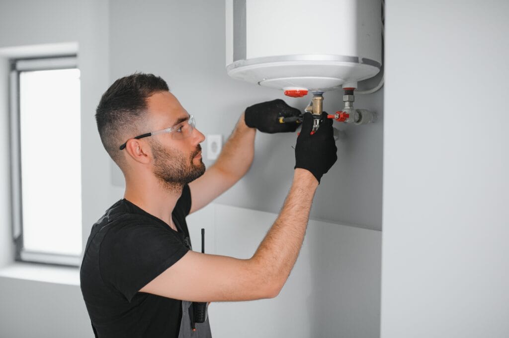 Technician performing water heater maintenance in Winter Haven