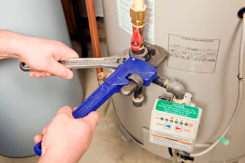 Plumber repairing a water heater valve in Winter Haven